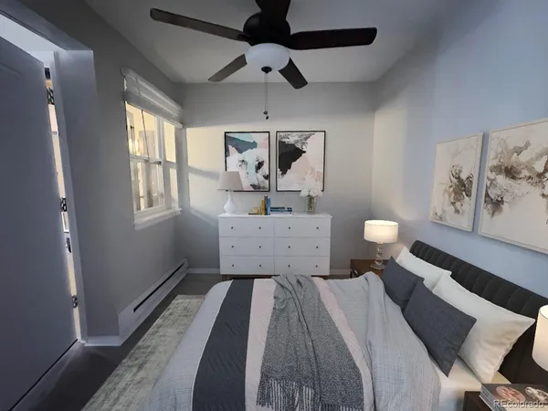 an empty room with windows and fan