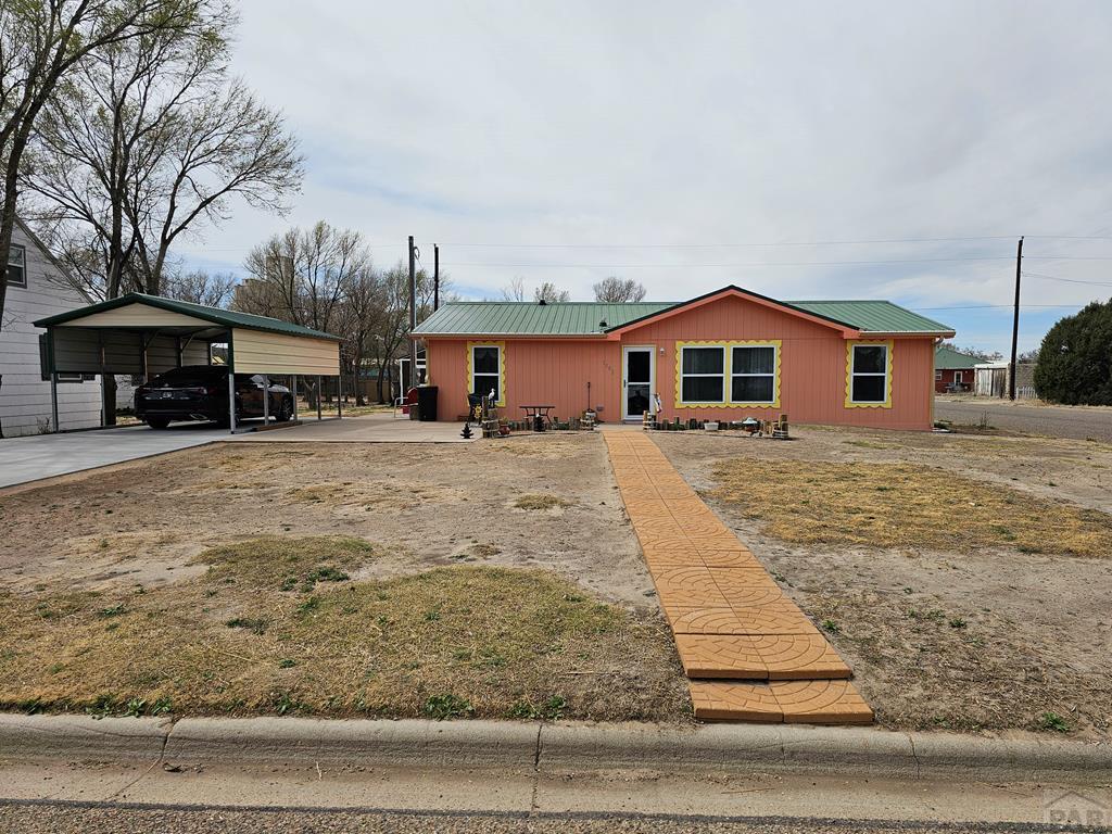 1302 Rittgers Street Eads, CO 81036 - Photo 1 of 29 a front view of a house with a yard