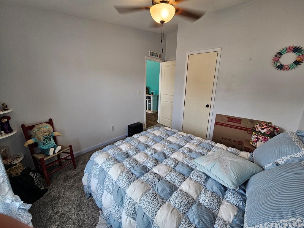 1302 Rittgers Street Eads, CO 81036 - Photo 16 of 29 a bedroom with a bed and a chandelier