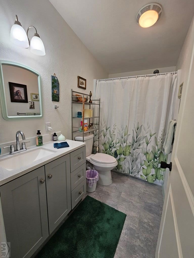 1302 Rittgers Street Eads, CO 81036 - Photo 17 of 29 a spacious bathroom with a toilet sink and mirror
