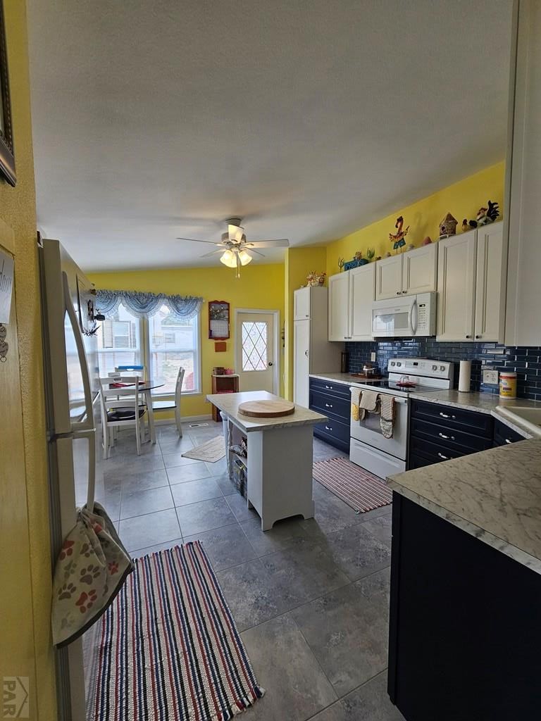 1302 Rittgers Street Eads, CO 81036 - Photo 4 of 29 a open kitchen with stainless steel appliances granite countertop a stove top oven a sink dishwasher and cabinets with wooden floor