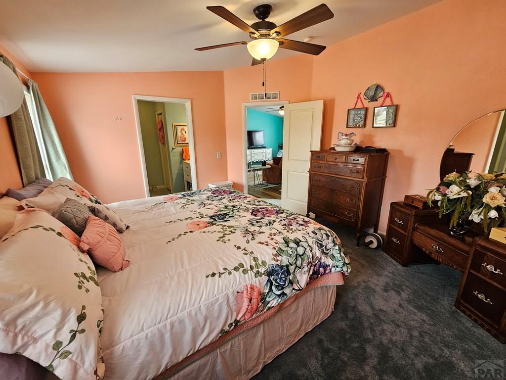 1302 Rittgers Street Eads, CO 81036 - Photo 10 of 29 a bedroom with a bed and a chandelier