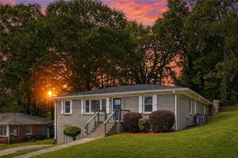 a front view of house with yard and green space
