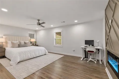 a spacious bedroom with a large bed and a fireplace