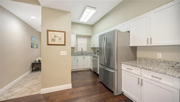 a kitchen with stainless steel appliances granite countertop a refrigerator and a stove top oven