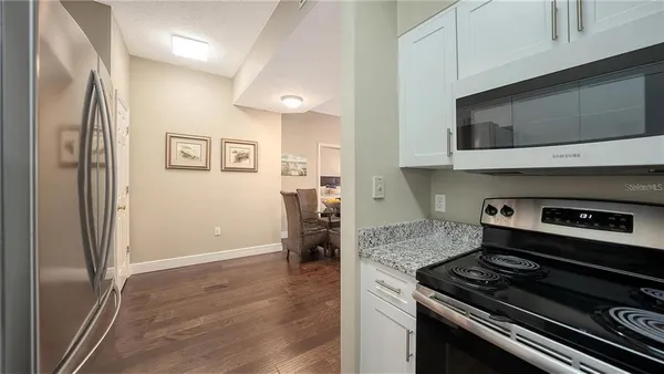 a kitchen with stainless steel appliances a stove a microwave and a refrigerator
