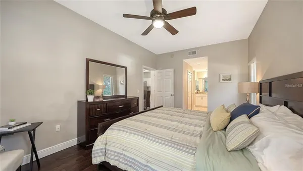a bedroom with a bed and wooden floor