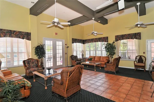a living room with furniture fireplace and a large window