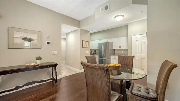 a view of a dining room with furniture and a potted plant