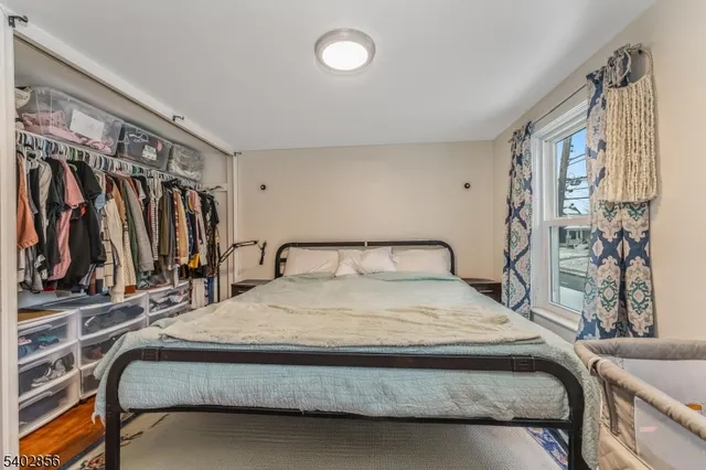 a bedroom with a bed and a walk in closet