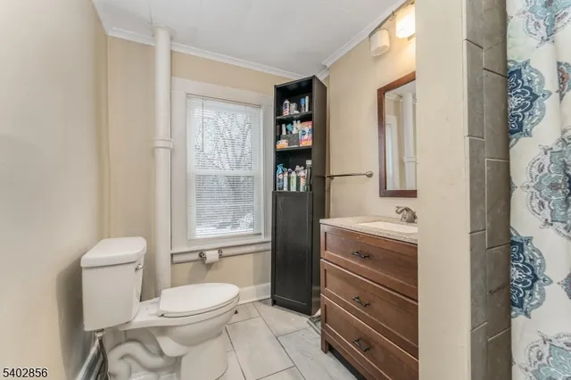 a bathroom with a toilet sink and shower