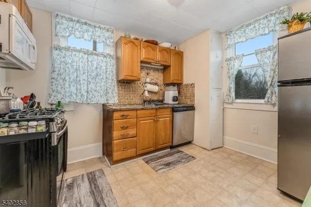 a kitchen with a stove a sink and a refrigerator