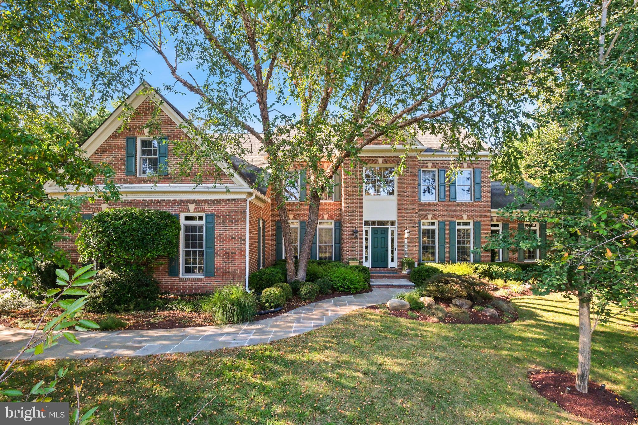 10405 Sandringham Court Potomac, MD 20854 - Photo 11 of 85 a front view of a house with garden and trees