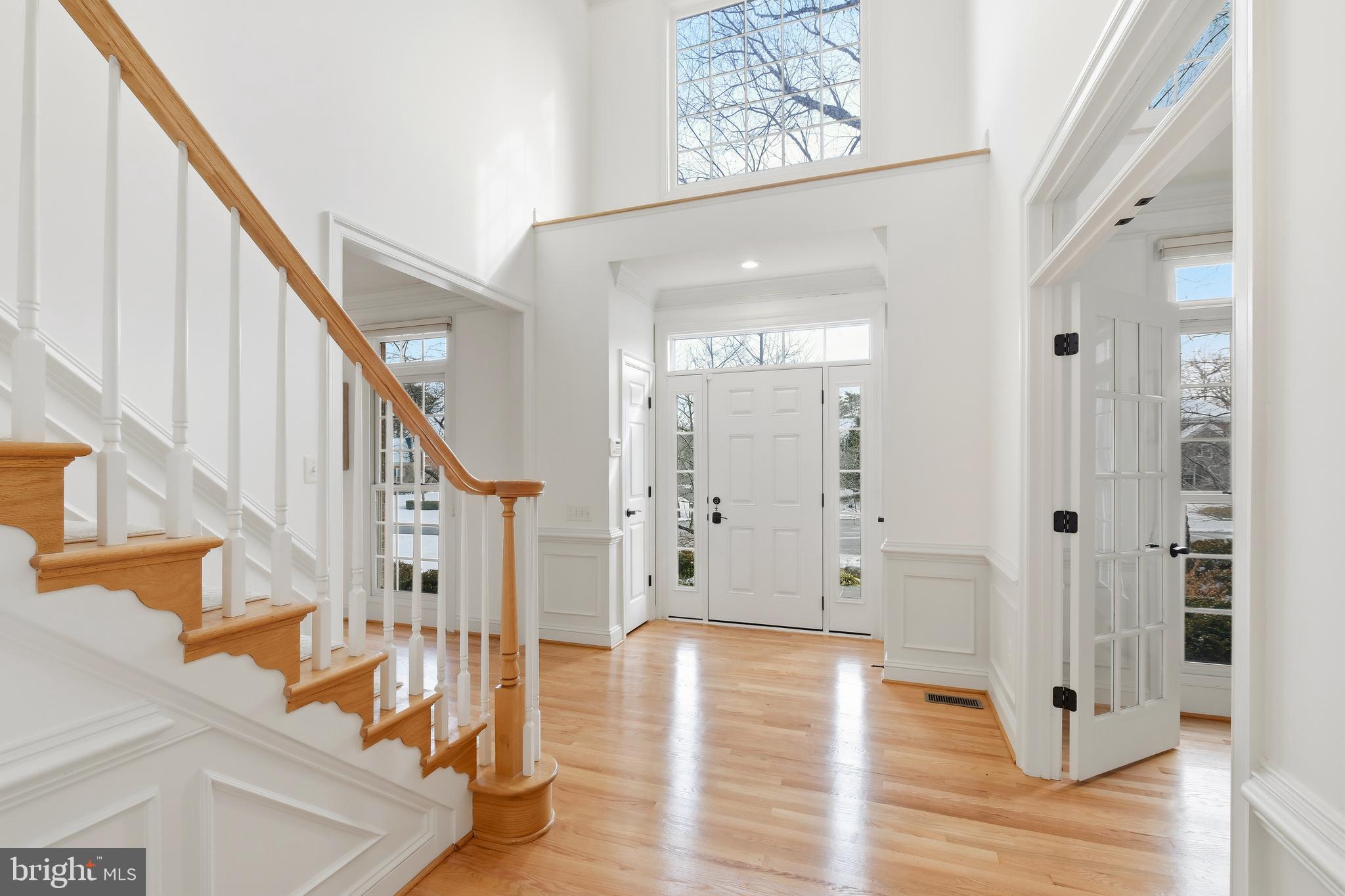 10405 Sandringham Court Potomac, MD 20854 - Photo 14 of 85 a view of an entryway with wooden floor and front door