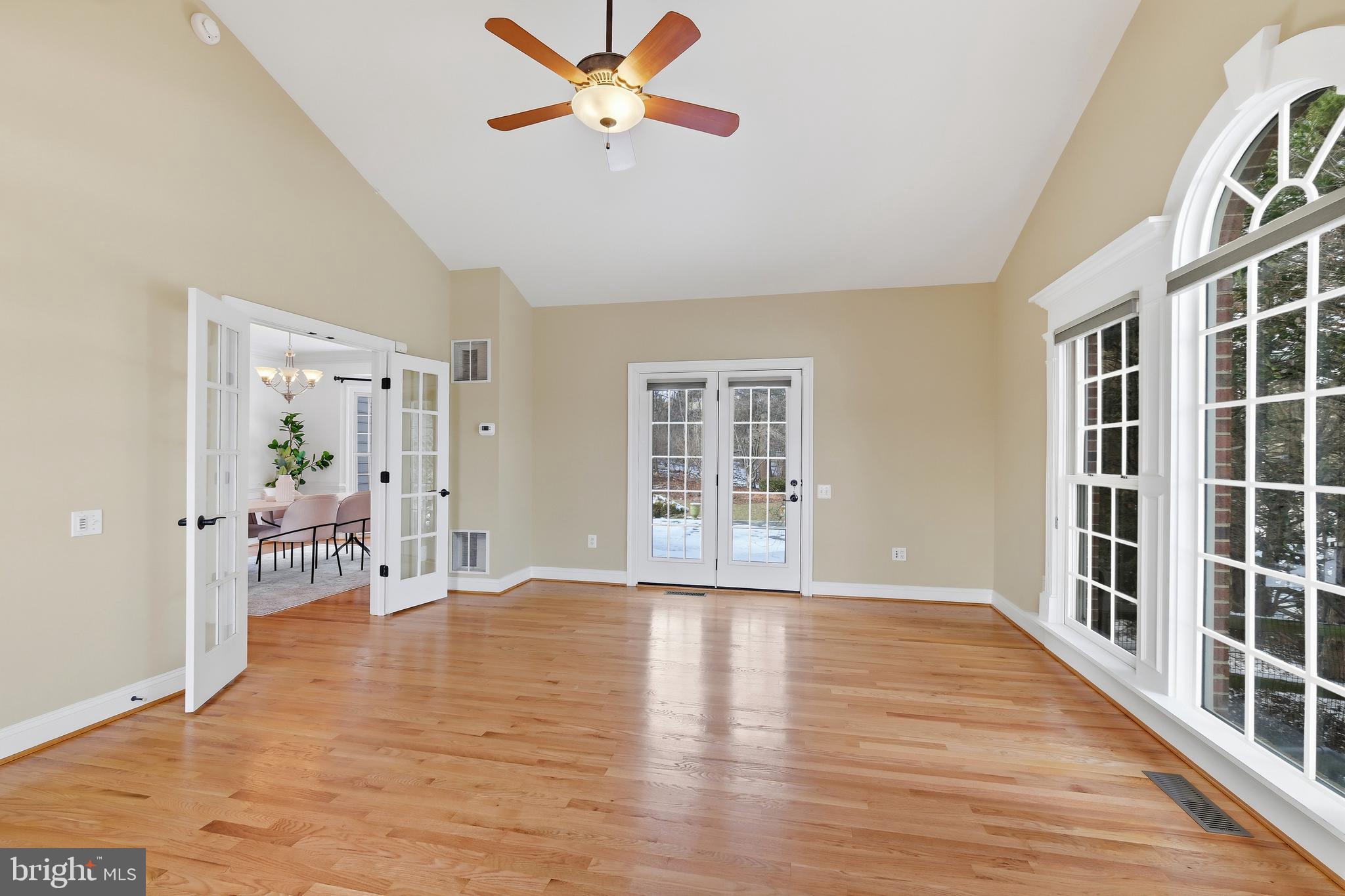 10405 Sandringham Court Potomac, MD 20854 - Photo 21 of 85 a view of a livingroom with wooden floor and a ceiling fan