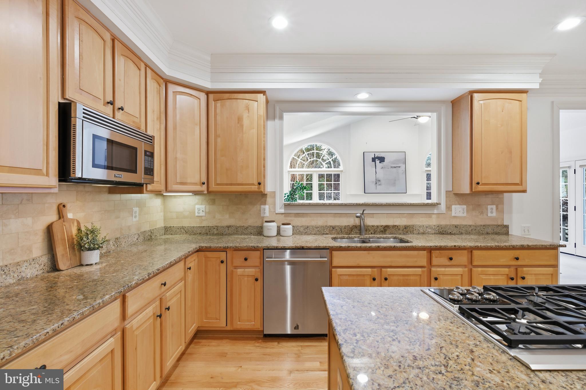 10405 Sandringham Court Potomac, MD 20854 - Photo 26 of 85 a kitchen with stainless steel appliances granite countertop a sink and stove top oven