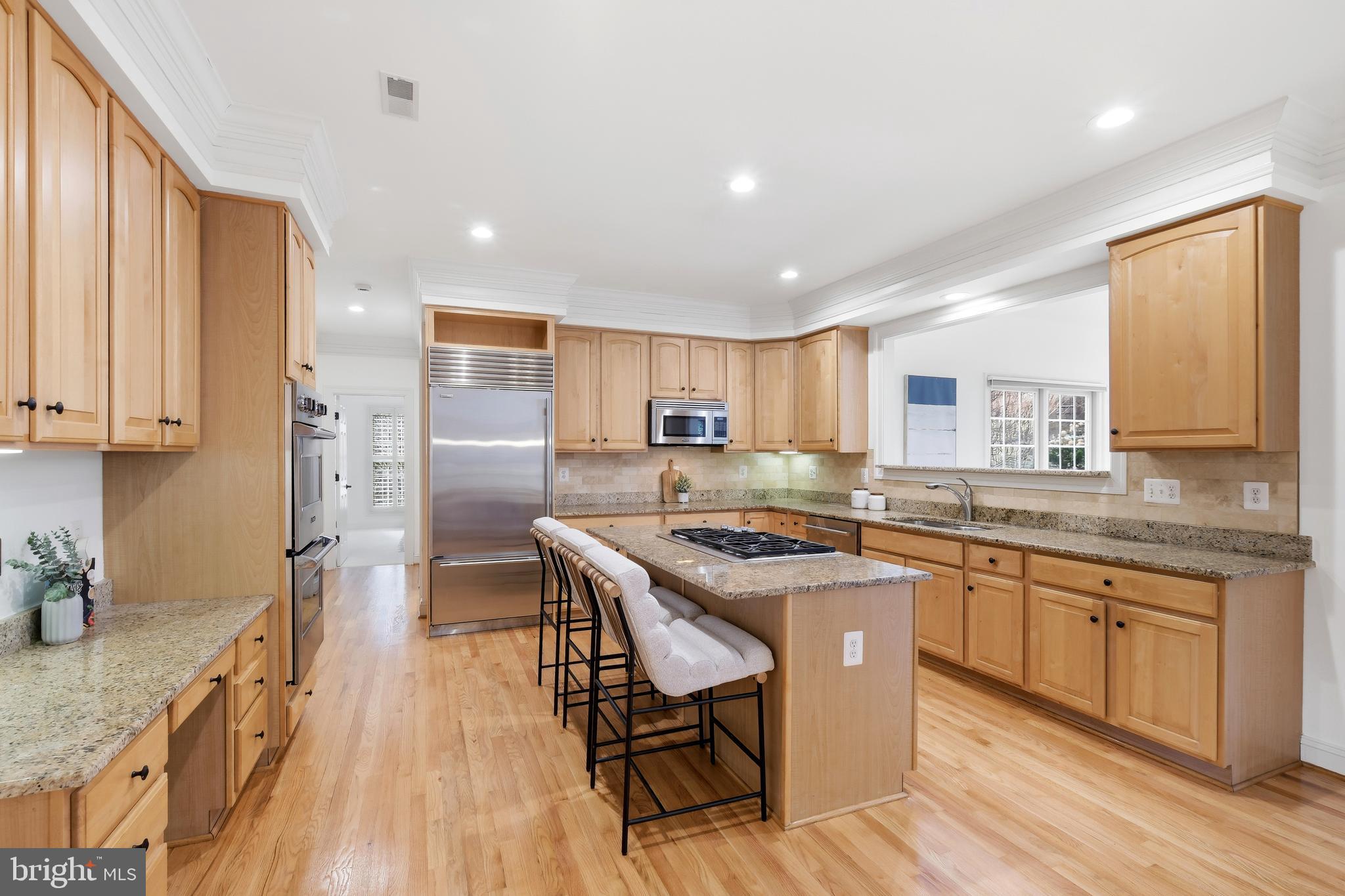 10405 Sandringham Court Potomac, MD 20854 - Photo 28 of 85 a kitchen with stainless steel appliances granite countertop counter space a sink and cabinets