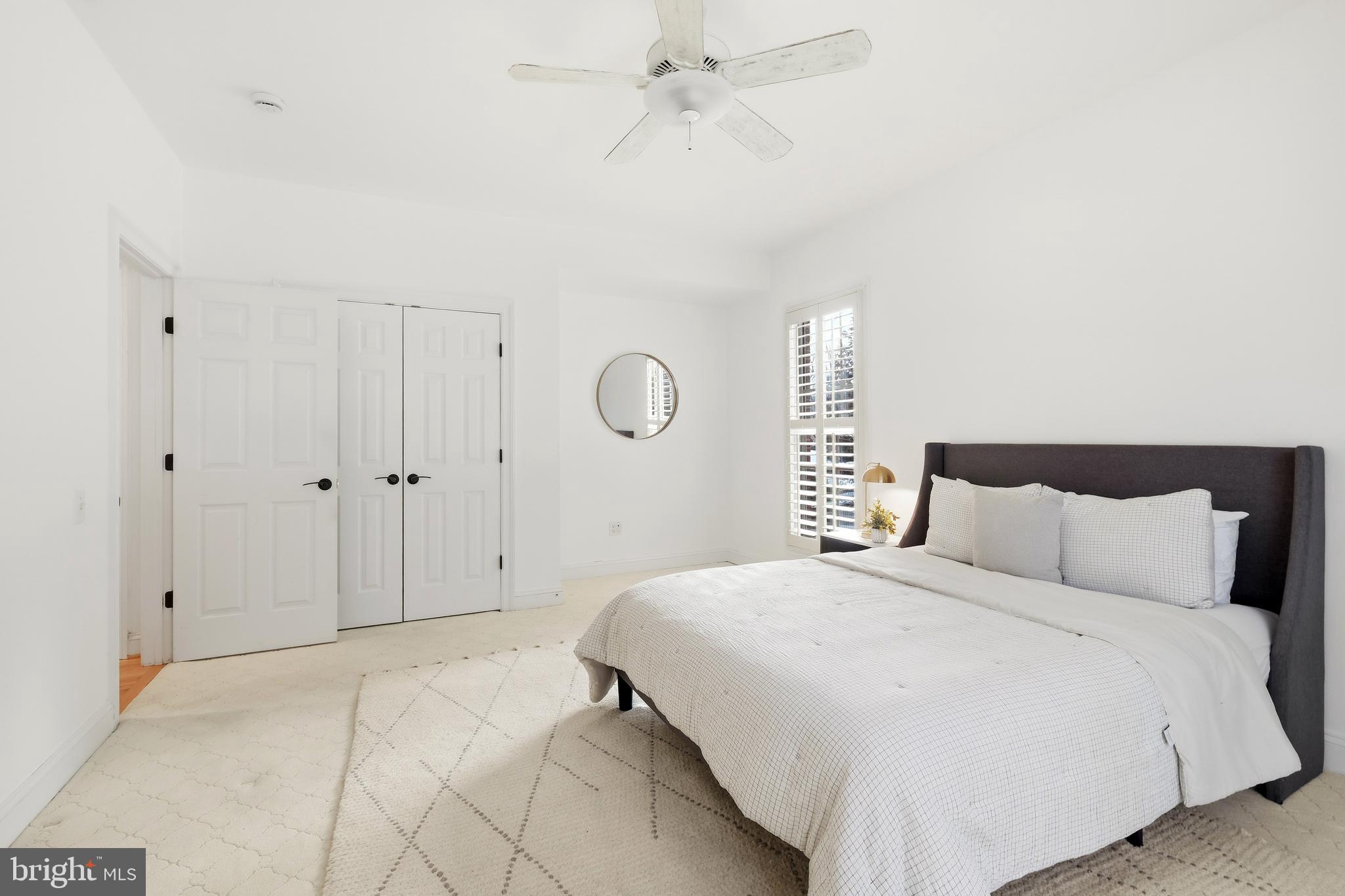 10405 Sandringham Court Potomac, MD 20854 - Photo 33 of 85 a bedroom with a large bed and a chandelier fan