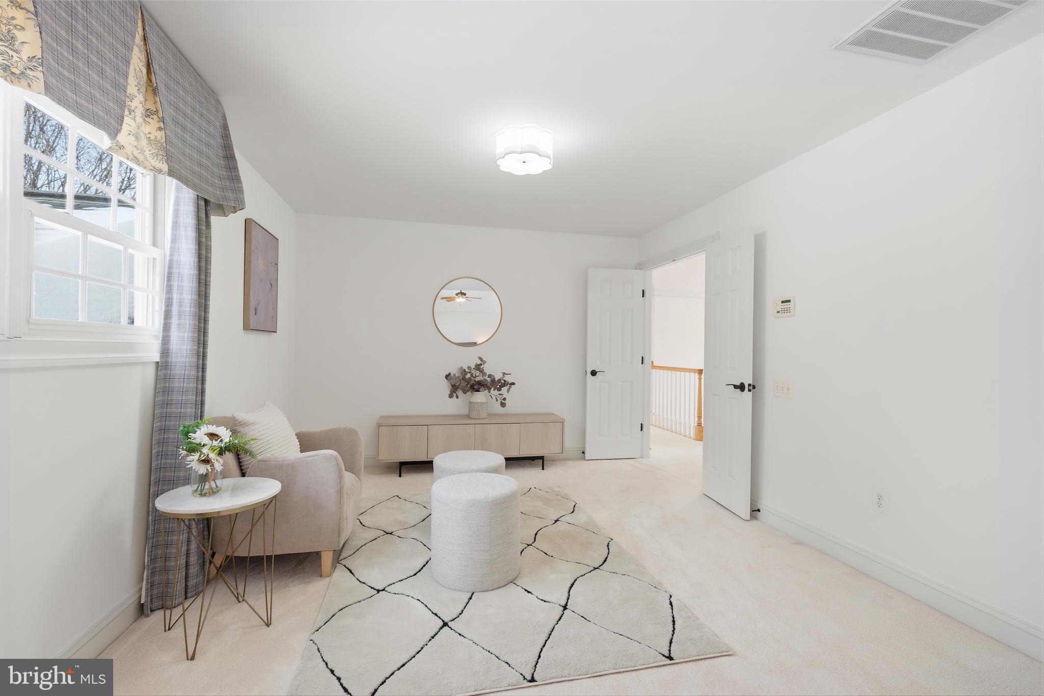 10405 Sandringham Court Potomac, MD 20854 - Photo 40 of 85 a living room with furniture and a table