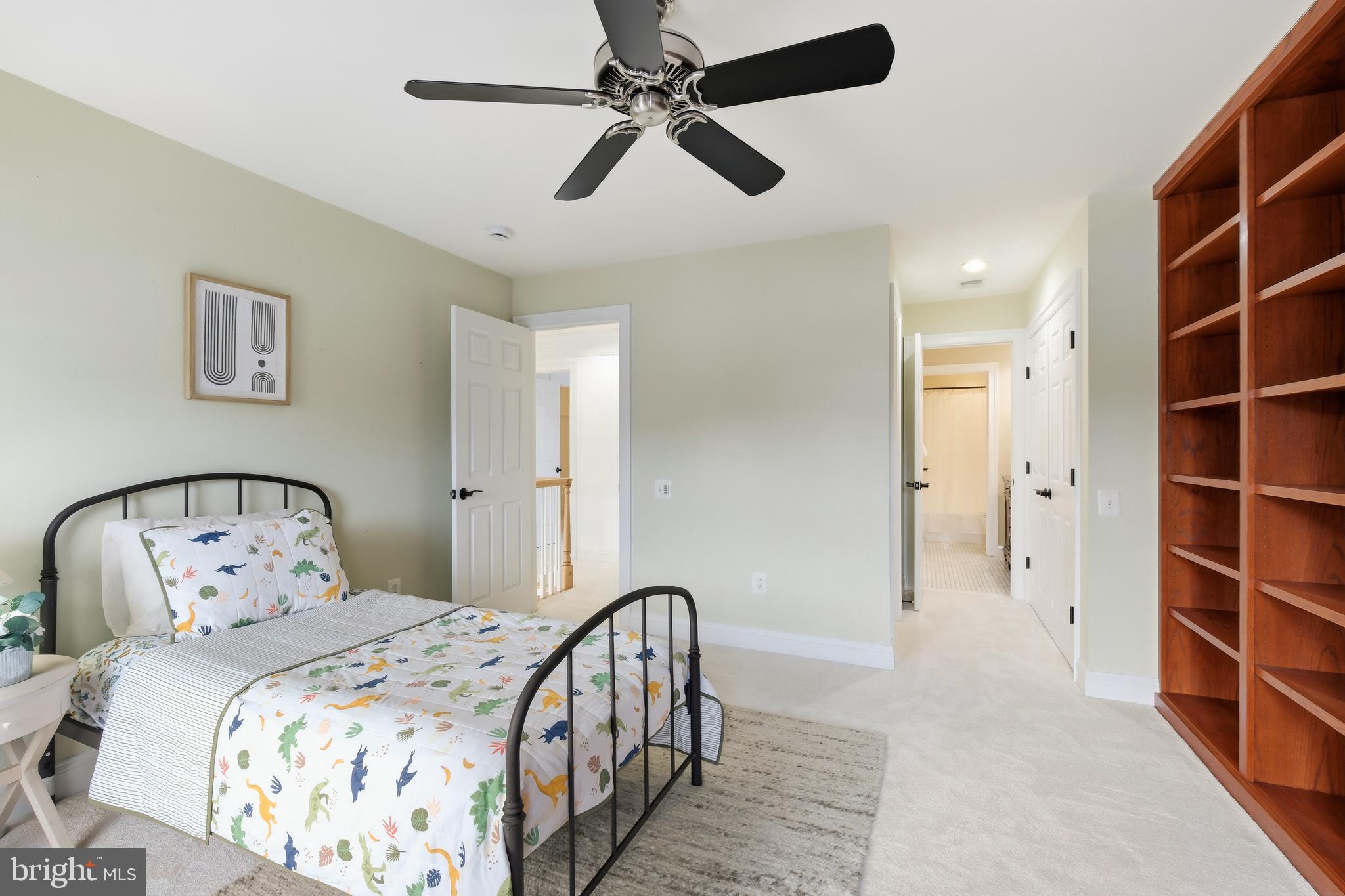 10405 Sandringham Court Potomac, MD 20854 - Photo 56 of 85 a bedroom with a bed and a chandelier