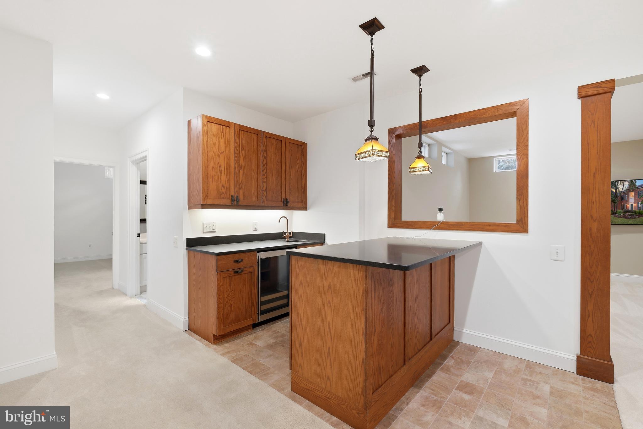 10405 Sandringham Court Potomac, MD 20854 - Photo 61 of 85 a kitchen with stainless steel appliances granite countertop a sink a stove and a wooden floor