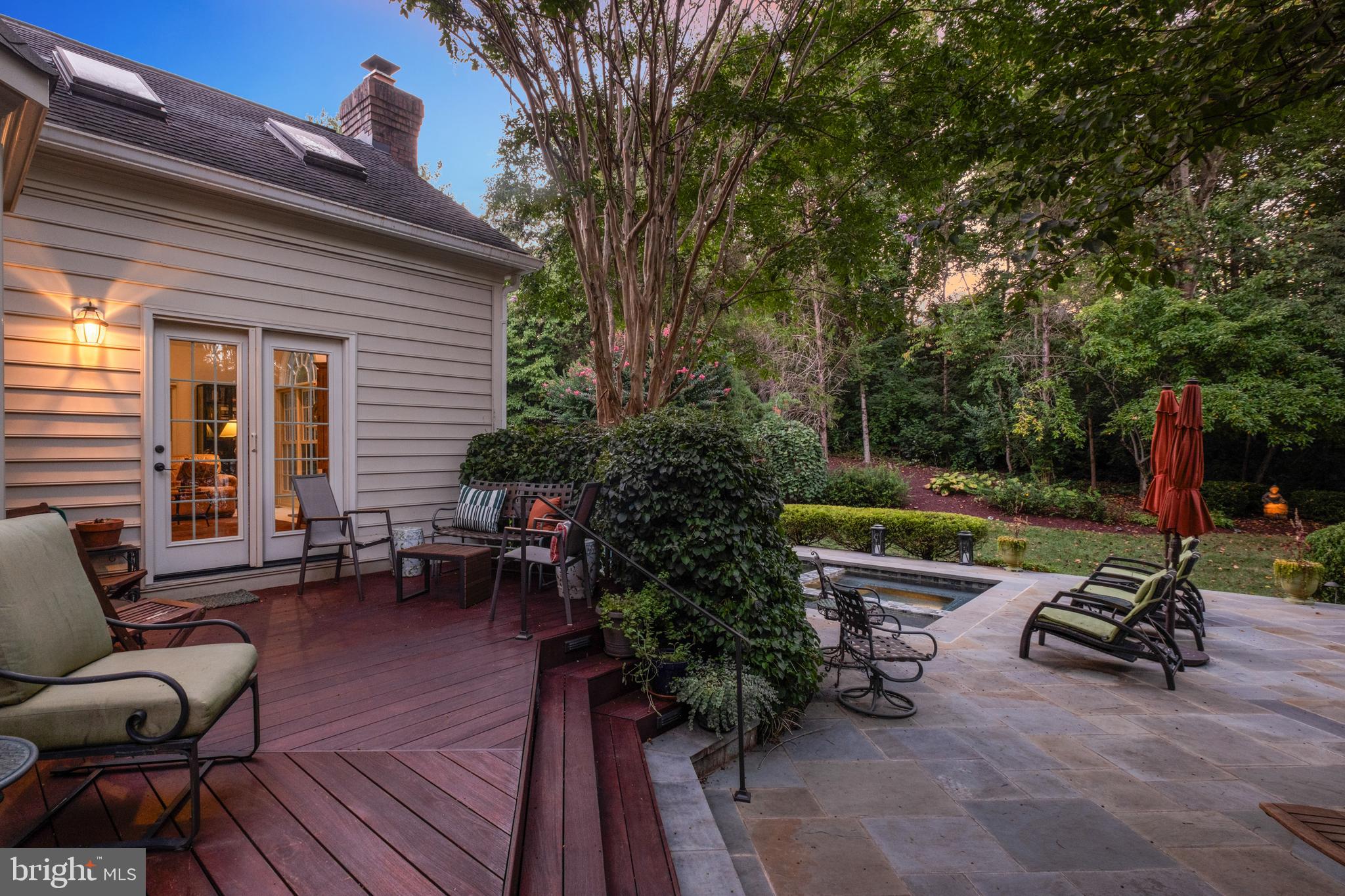 10405 Sandringham Court Potomac, MD 20854 - Photo 72 of 85 a view of a patio with couches and chairs under an umbrella