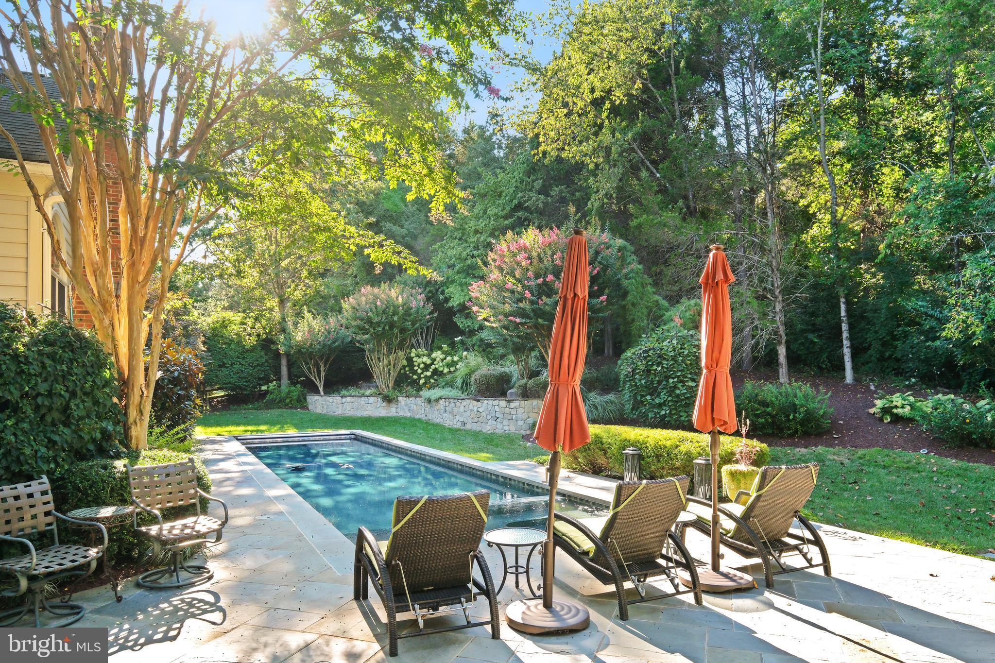 10405 Sandringham Court Potomac, MD 20854 - Photo 74 of 85 a view of a sitting area with chairs and table in the yard
