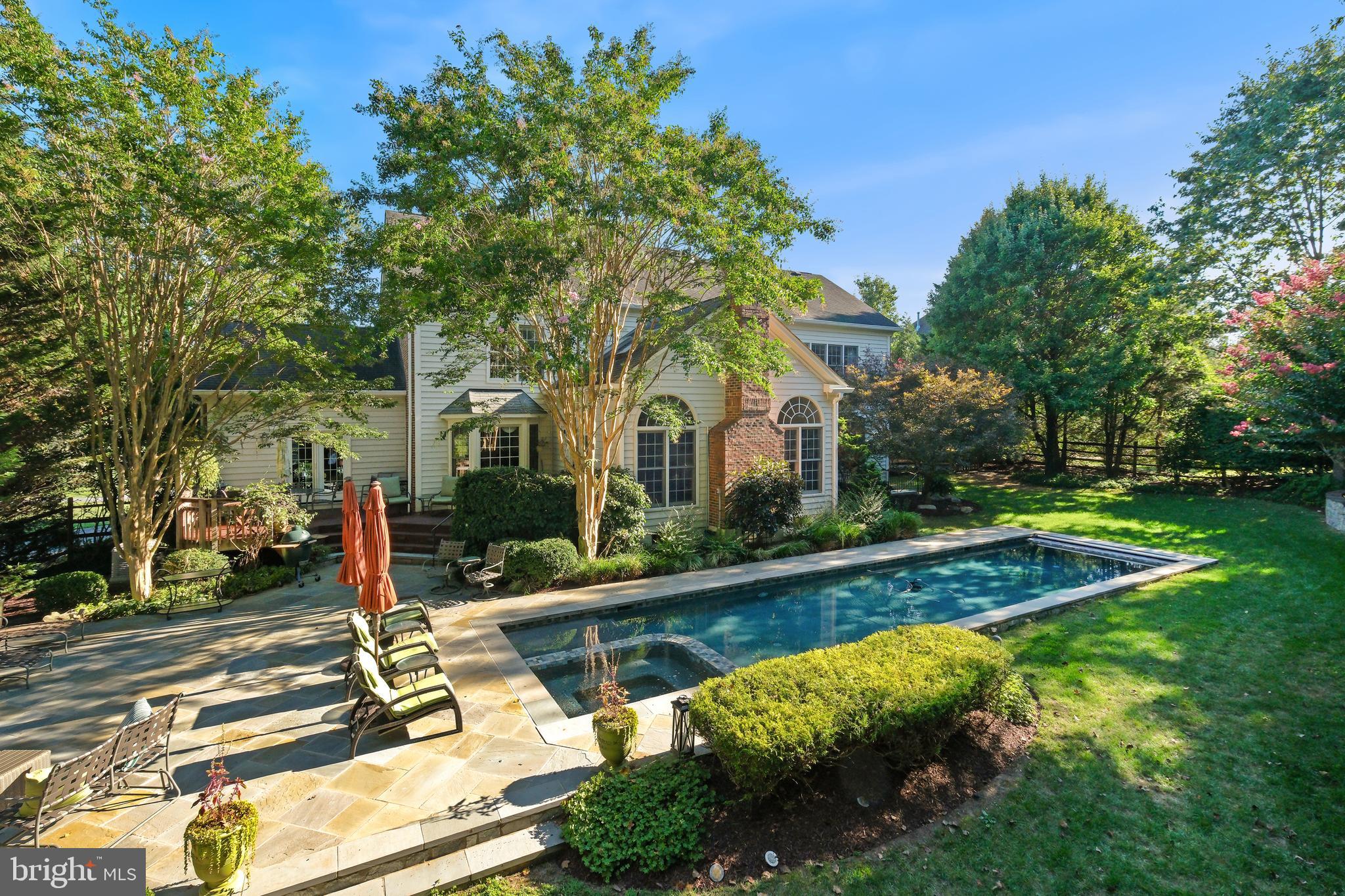 10405 Sandringham Court Potomac, MD 20854 - Photo 77 of 85 a view of a house with pool and trees around