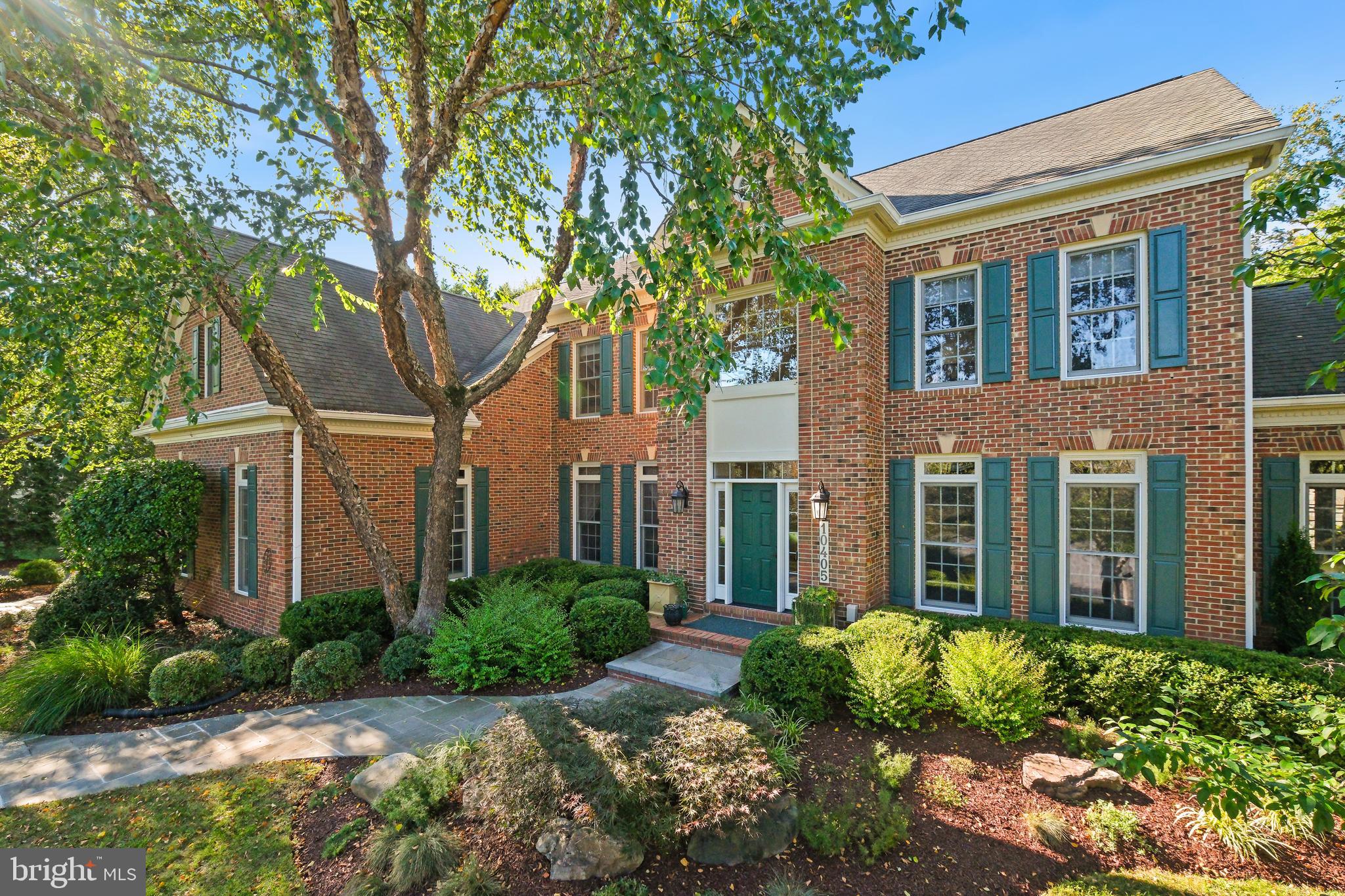 10405 Sandringham Court Potomac, MD 20854 - Photo 9 of 85 a front view of a house with garden and trees