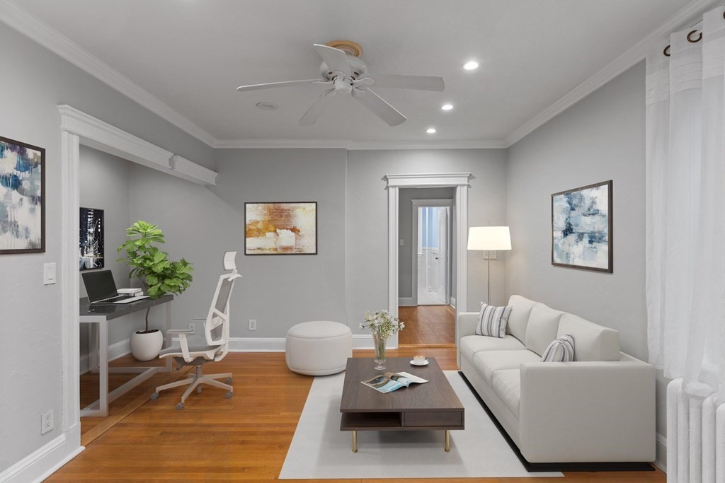 a living room with furniture and a painting on the wall