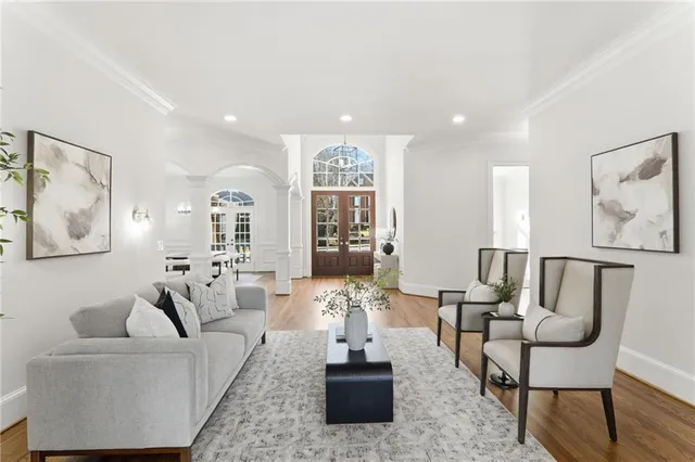 a dining room with furniture potted plants and wooden floor