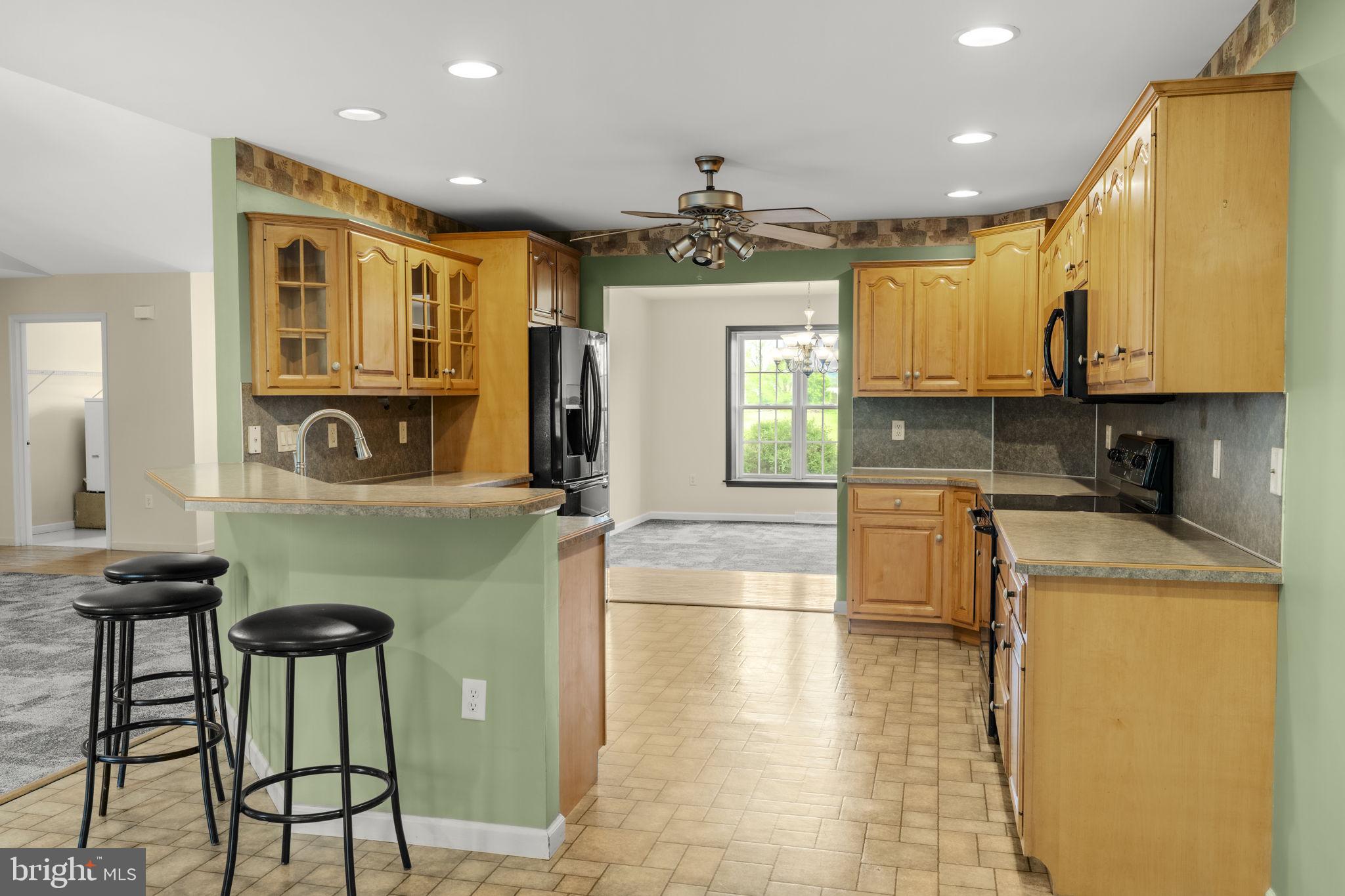 331 Brunners Grove Road Reinholds, PA 17569 - Photo 22 of 62 a kitchen with kitchen island granite countertop a stove a sink a dining table and chairs