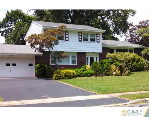 10 Gulf Road East Brunswick, NJ 08816 - Photo 2 of 25 a front view of a house with a yard and garage