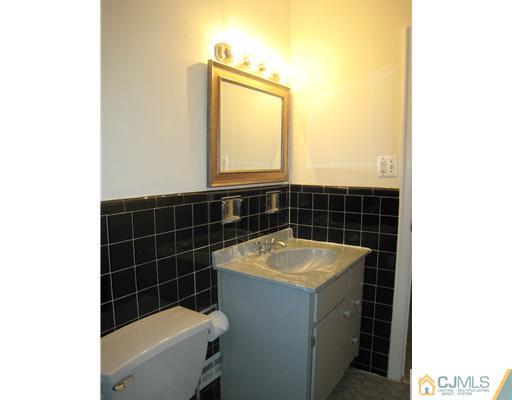 10 Gulf Road East Brunswick, NJ 08816 - Photo 12 of 25 a bathroom with a sink and a bathtub