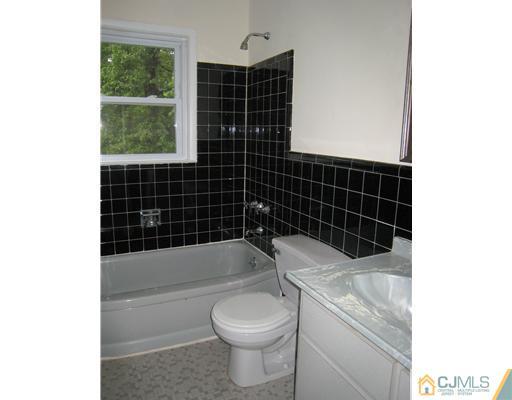 10 Gulf Road East Brunswick, NJ 08816 - Photo 14 of 25 a bathroom with a toilet a bath tub and a shower