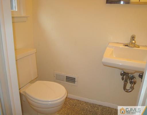 10 Gulf Road East Brunswick, NJ 08816 - Photo 20 of 25 a bathroom with a toilet and a sink