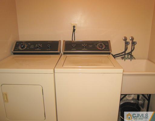 10 Gulf Road East Brunswick, NJ 08816 - Photo 21 of 25 a close up view of a sink and utility room with washer and dryer