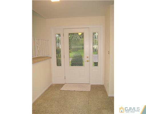 10 Gulf Road East Brunswick, NJ 08816 - Photo 5 of 25 a view of an empty room with floor to ceiling windows