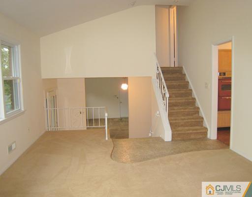 10 Gulf Road East Brunswick, NJ 08816 - Photo 7 of 25 a view of a livingroom with wooden floor and stairs