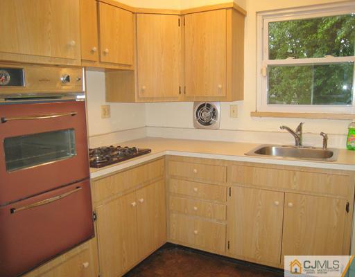 10 Gulf Road East Brunswick, NJ 08816 - Photo 9 of 25 a kitchen with a sink and a stove