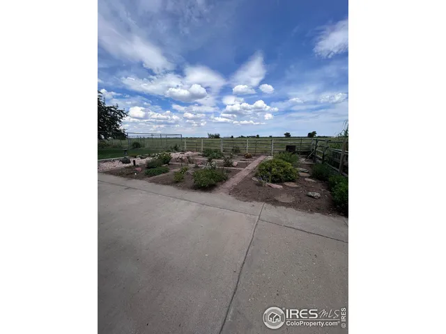 a view of a backyard with sitting area