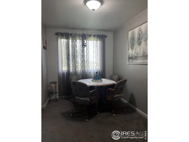 a view of a room with furniture and window