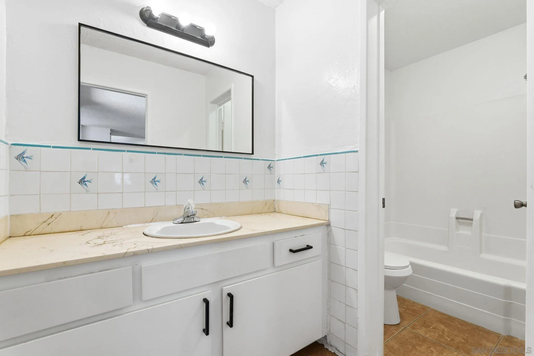 262 Rancho Drive, Unit C Chula Vista, CA 91911 - Photo 11 of 29 a bathroom with a granite countertop sink a toilet and a mirror
