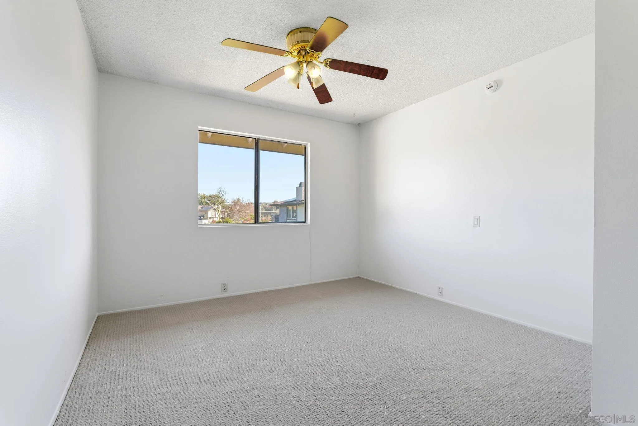262 Rancho Drive, Unit C Chula Vista, CA 91911 - Photo 15 of 29 an empty room with a window and a ceiling fan