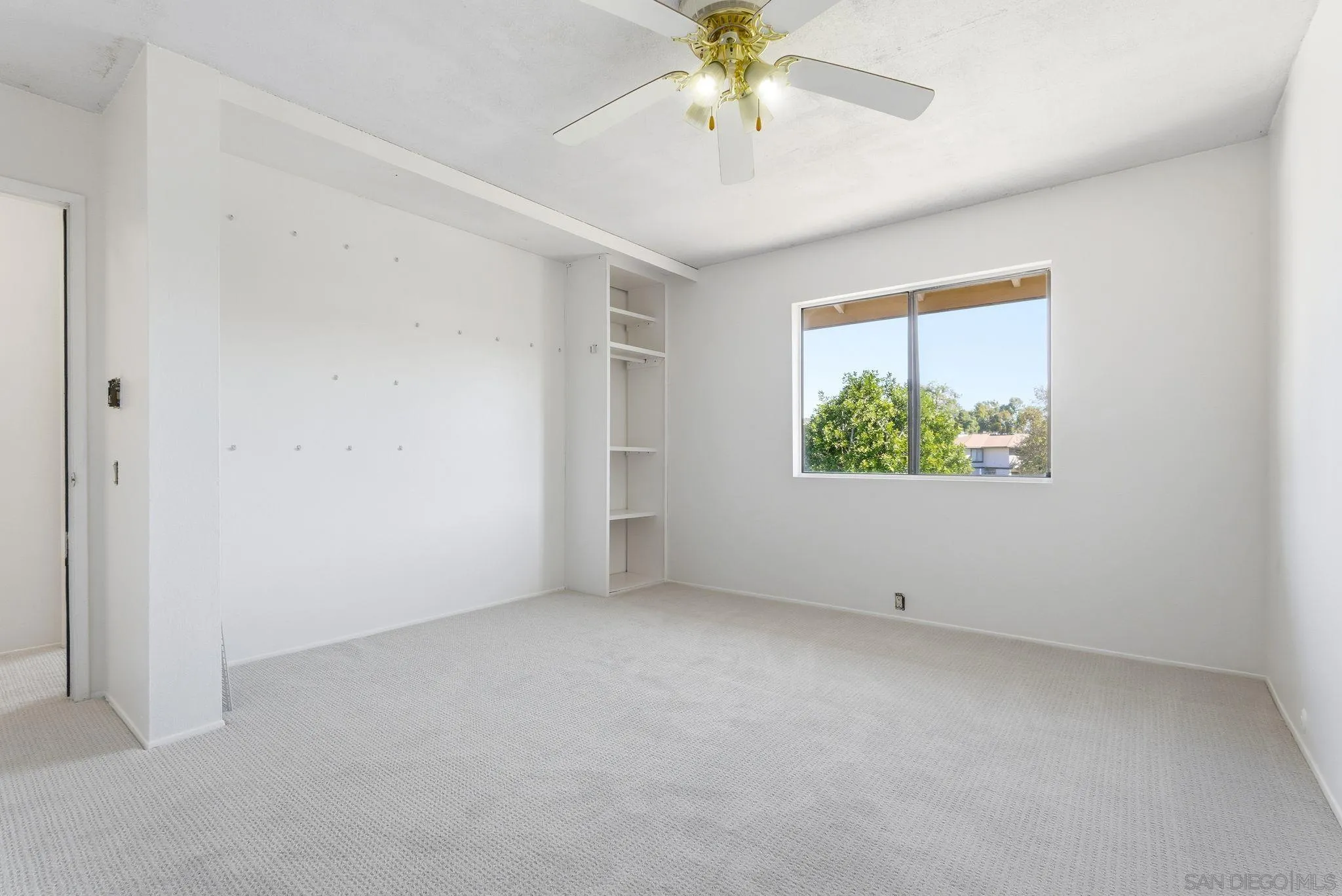 262 Rancho Drive, Unit C Chula Vista, CA 91911 - Photo 17 of 29 an empty room with a window and a ceiling fan