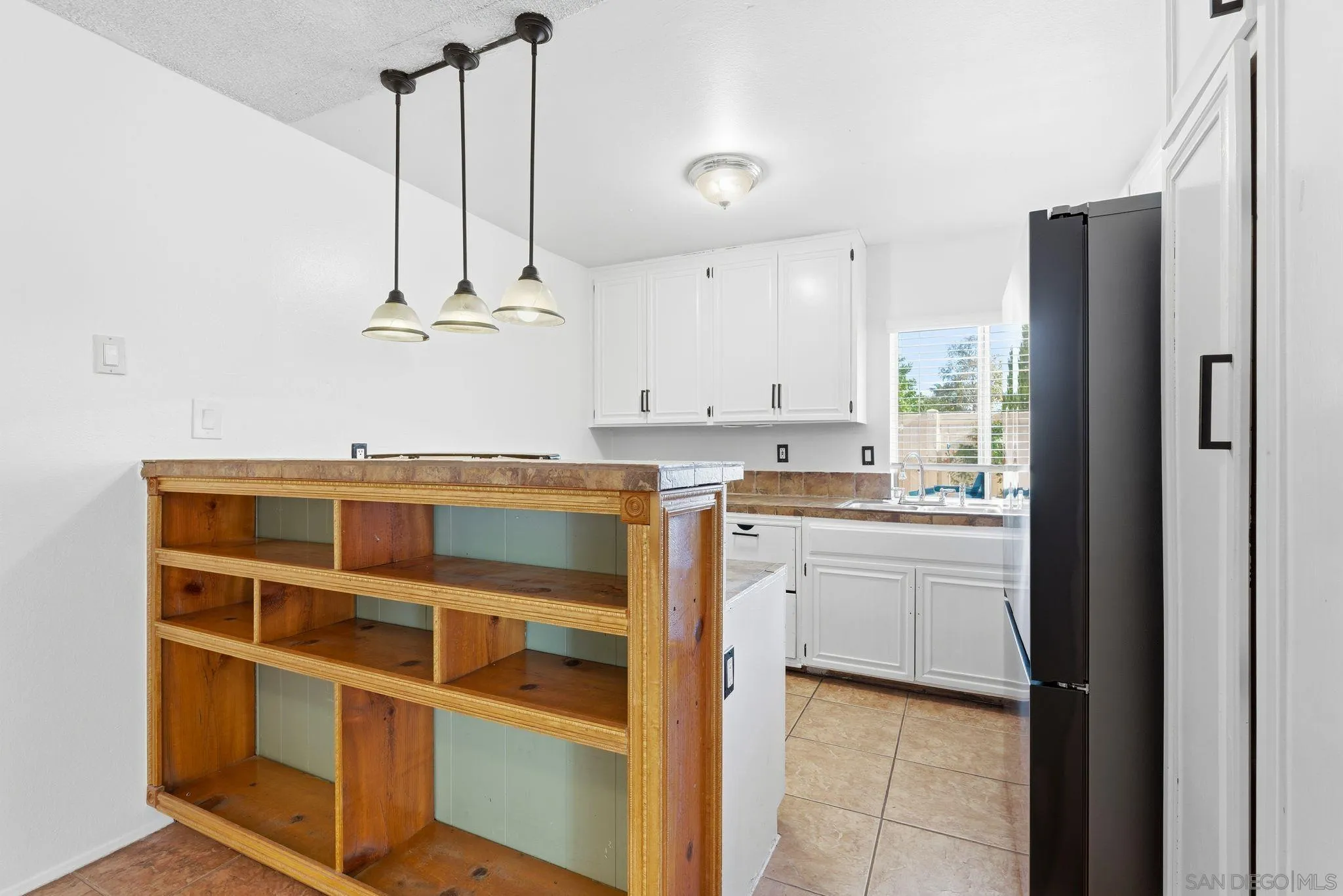 262 Rancho Drive, Unit C Chula Vista, CA 91911 - Photo 7 of 29 a kitchen with stainless steel appliances granite countertop a refrigerator a sink and white cabinets
