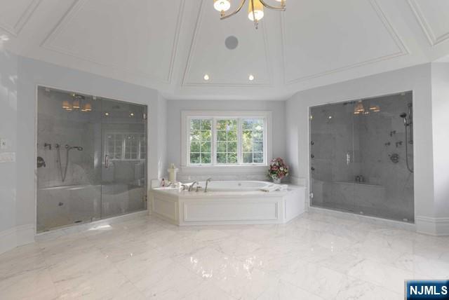 51 Chestnut Ridge Road Saddle River, NJ 07458 - Photo 21 of 45 a bathroom with a bathtub shower sink and mirror