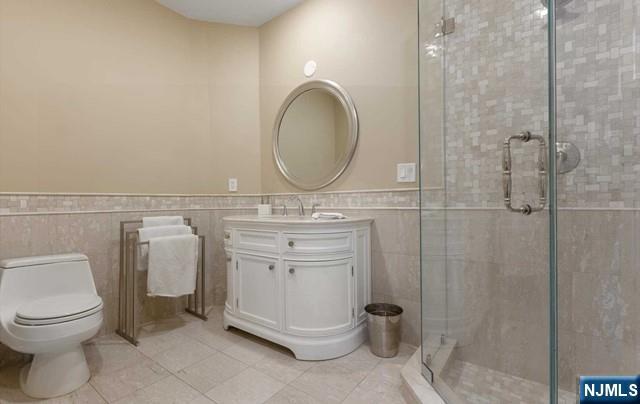 51 Chestnut Ridge Road Saddle River, NJ 07458 - Photo 24 of 45 a bathroom with a toilet sink and a mirror