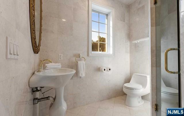 51 Chestnut Ridge Road Saddle River, NJ 07458 - Photo 26 of 45 a bathroom with a toilet sink and mirror