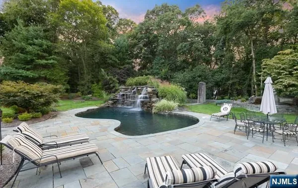 a view of house with backyard outdoor seating and green space